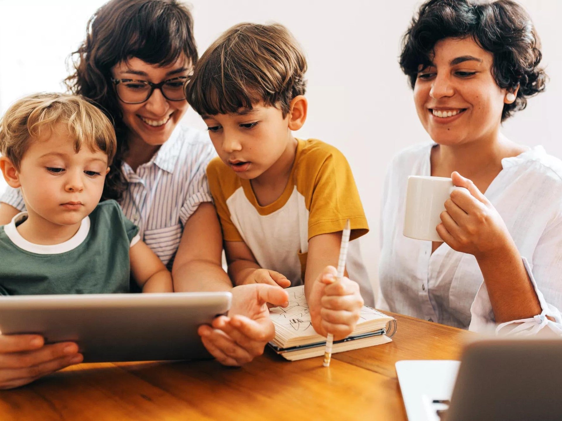 A family sitting together looking at a tablet.