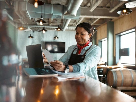 Woman working on a laptop in her small business.
